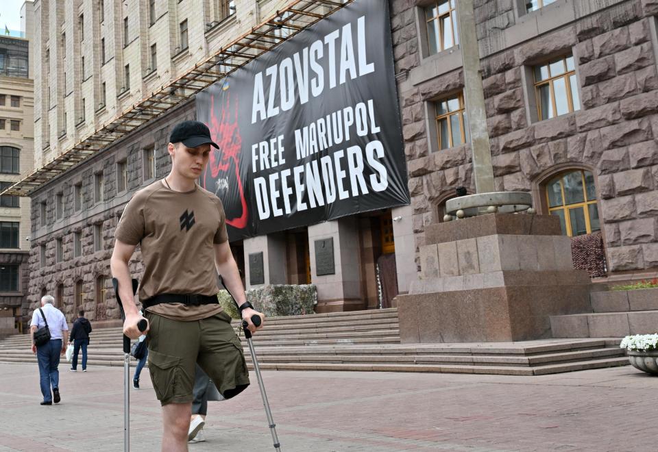 This photograph taken on August 16, 2022 shows Ukranian Vladyslav Zhaivoronok walking in Kyiv. - Vladyslav Zhaivoronok's contract with his Ukrainian army unit expired on February 21, three days before Russia's invasion of Ukraine began. But the 29-year-old Azov Regiment soldier is confident he made the 
