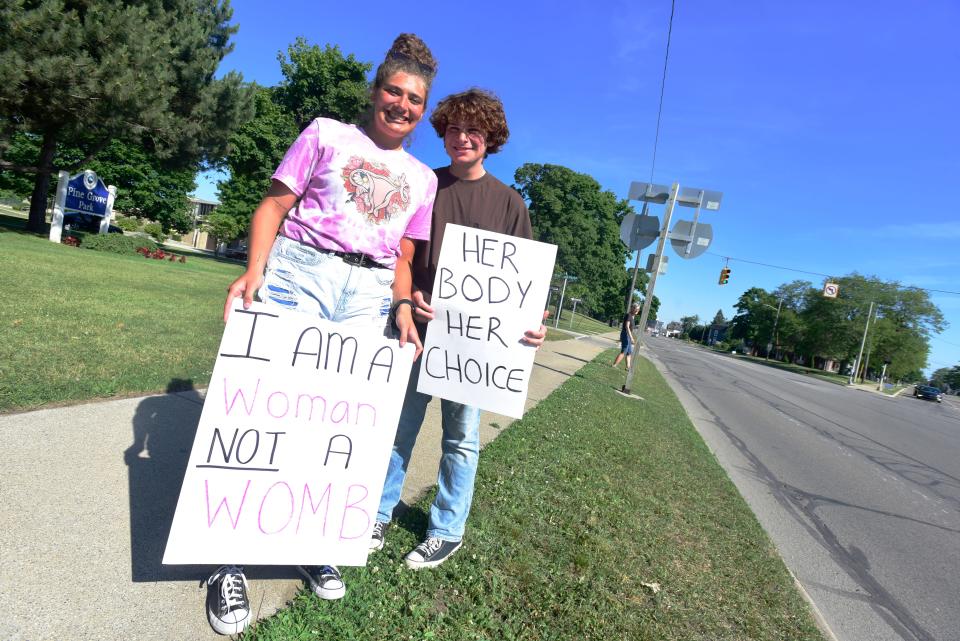 Jaden Walker (left) and Aaron Walker stand on the sidewalk along Pine Grove Avenue during a rally for abortion rights at Pine Grove Park in Port Huron on Friday, June 24, 2022. The rally was organized following the long-expected decision from SCOTUS overturning Roe vs. Wade.