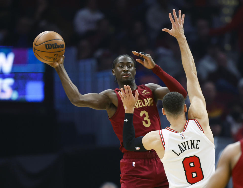Cleveland Cavaliers guard Caris LeVert (3) passes the ball against Chicago Bulls guard Zach LaVine (8) during the first half of an NBA basketball game, Monday, Jan. 2, 2023, in Cleveland. (AP Photo/Ron Schwane)