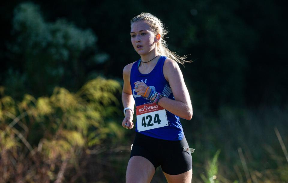 Sienna Audrey from Community School of Naples leads the FHSAA Girls Region 1A-R3 Cross Country Championship at Holloway Park in Lakeland on Thursday, Nov. 9, 2023. She won and led her team to a second place finish.