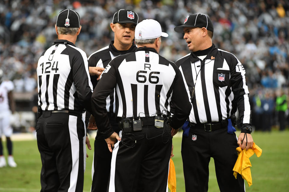 <p>Officials confer after a fight between Michael Crabtree #15 of the Oakland Raiders and Aqib Talib #21 of the Denver Broncos during their NFL game at Oakland-Alameda County Coliseum on November 26, 2017 in Oakland, California. Both players were ejected from the game. (Photo by Robert Reiners/Getty Images) </p>