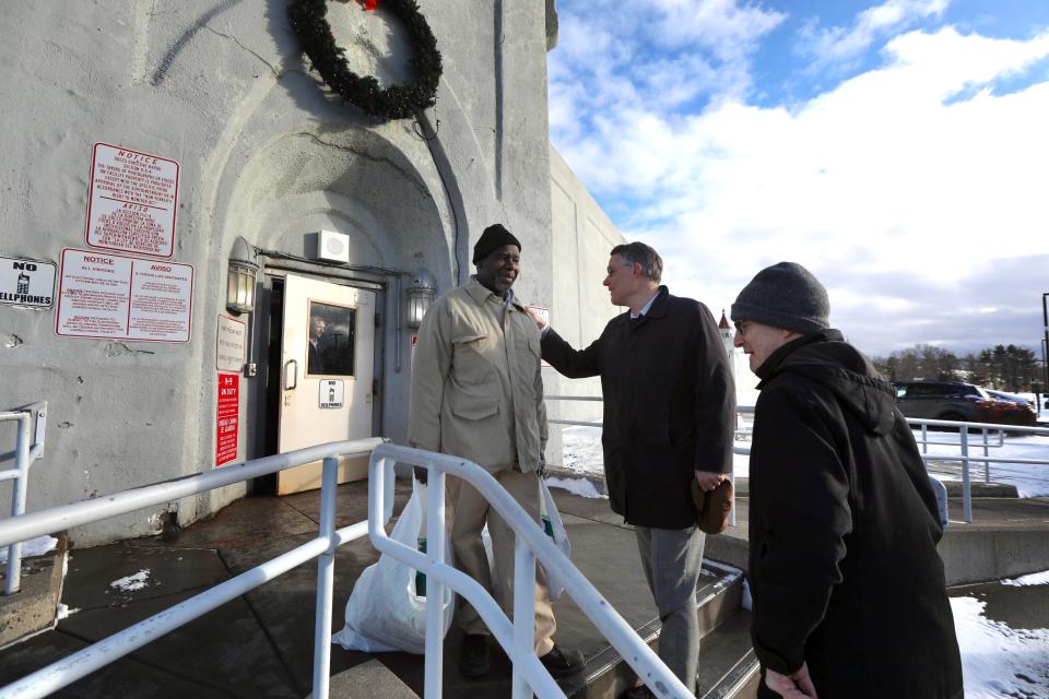 Attorneys Pierre Sussman and Robert Grossman greet Michael Rhynes as he leaves the Attica Correction Facility a free man.