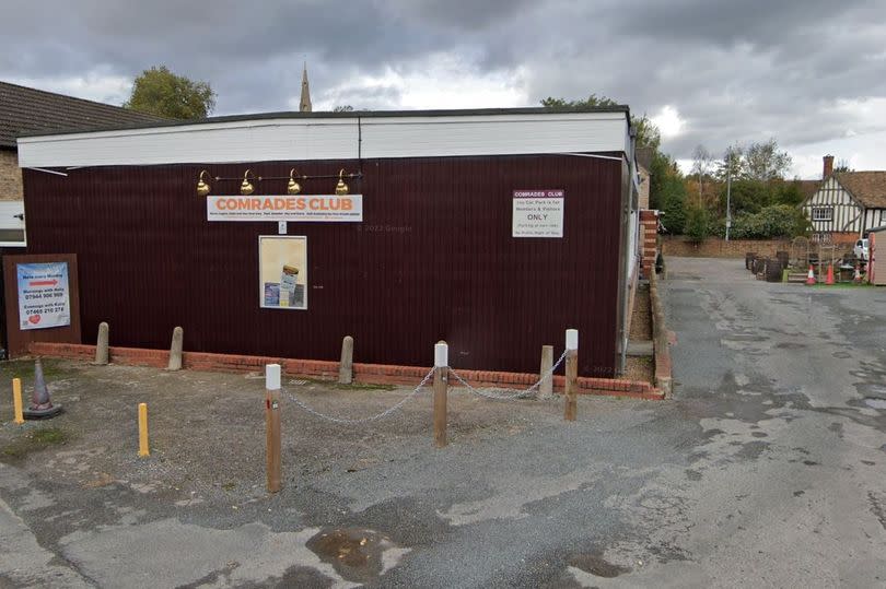 Single storey club building with car park to the right.