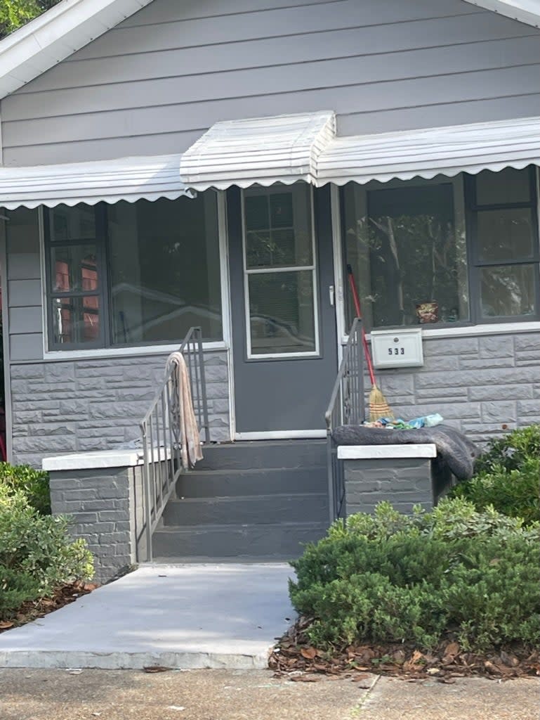 The outside of a Florida landlord's rental home after being taken over by squatters