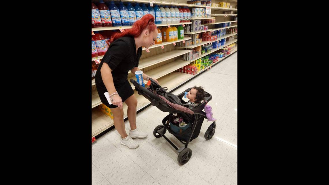 This undated photo provided by Deatrie Young shows Jazmin Valentine and her baby at a supermarket.