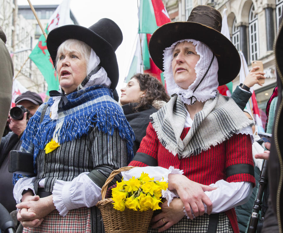 Women in traditional Welsh dress sing the Welsh national anthem during St David's Day parade on March 1, 2017 in Cardiff, Wales. | Mark Hawkins—Barcroft Media/Getty Images