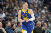 Golden State Warriors guard Donte DiVincenzo reacts after hitting a 3-point basket against the Denver Nuggets in the first half of an NBA basketball game, Thursday, Feb. 2, 2023, in Denver. (AP Photo/David Zalubowski)