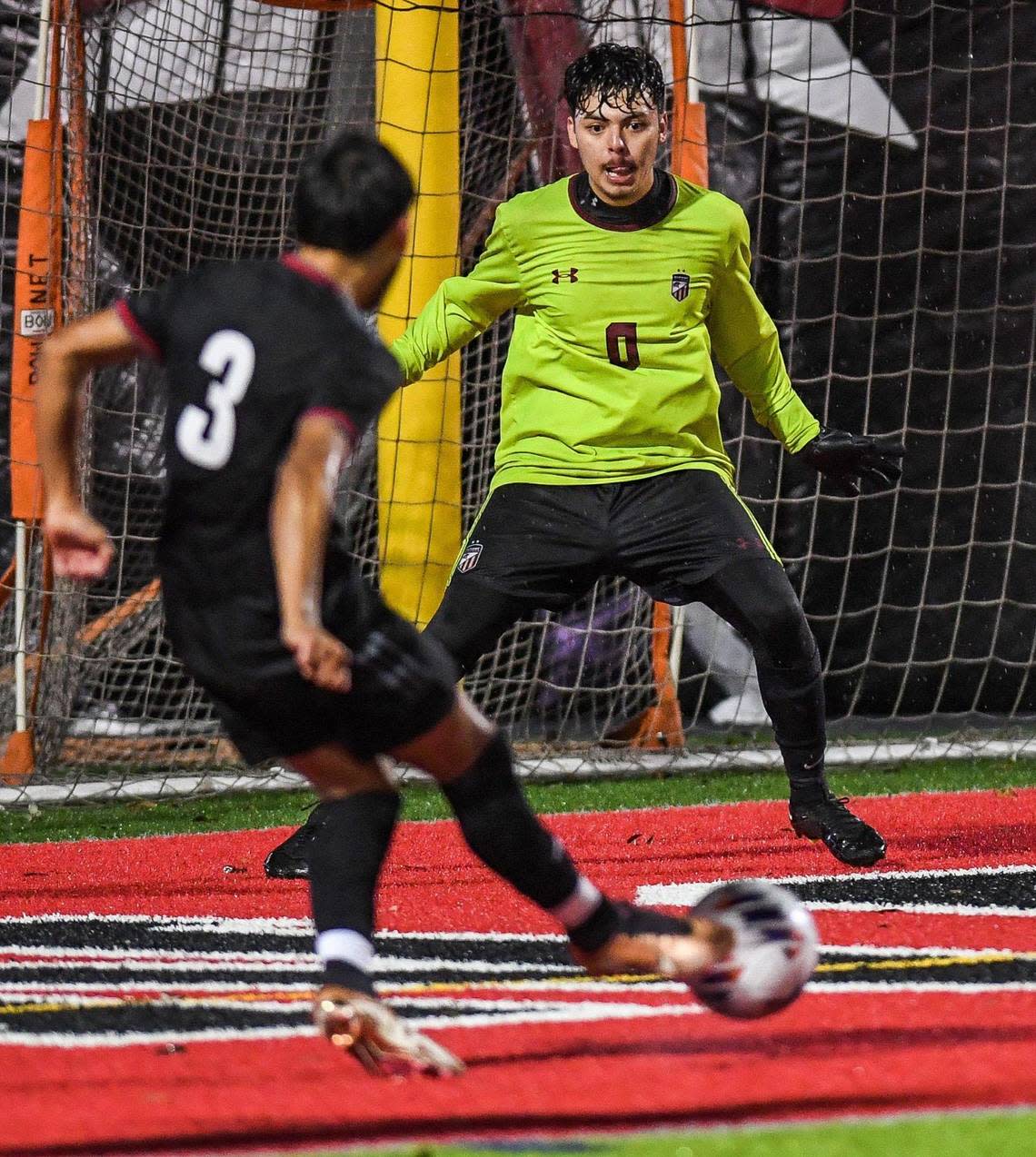 McLane’s Guillermo Martinez kicks the ball past Chavez goal keeper Jonathan Andrade for the first score of the game during their Central Section Division III boys soccer championship game at McLane Stadium on Friday, Feb. 24, 2023.