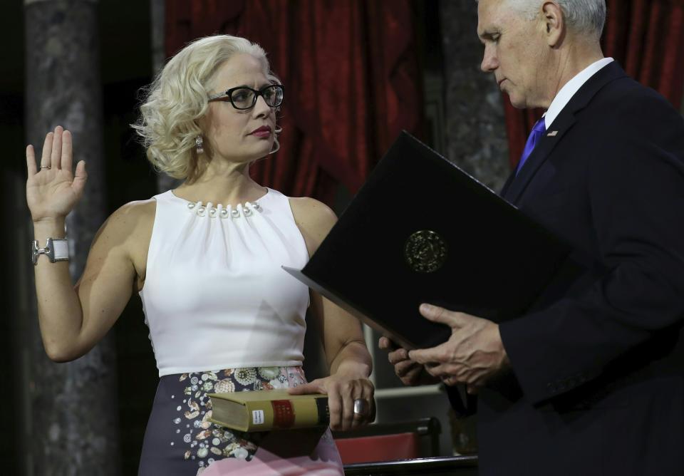 Sen. Kyrsten Sinema (D-Ariz.) participates in a ceremonial swearing-in on January 3, 2019. Rather than use a traditional Bible, she placed her hand on&nbsp;a book from the Library of Congress that contains the texts of the Arizona and U.S. constitutions, a spokesperson said. (Photo: ALEX EDELMAN via Getty Images)