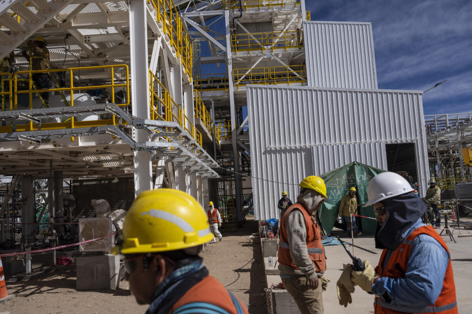 Workers walk through the construction of the Cauchari-Olaroz Exar lithium mine in Jujuy Province, Argentina, Tuesday, April 22, 2023. Doors for mining companies have been left wide open under the country’s new right-wing “anarcho-capitalist” President Javier Milei, who was elected in November, under a promise to fix his country’s spiraling economy. (AP Photo/Rodrigo Abd)