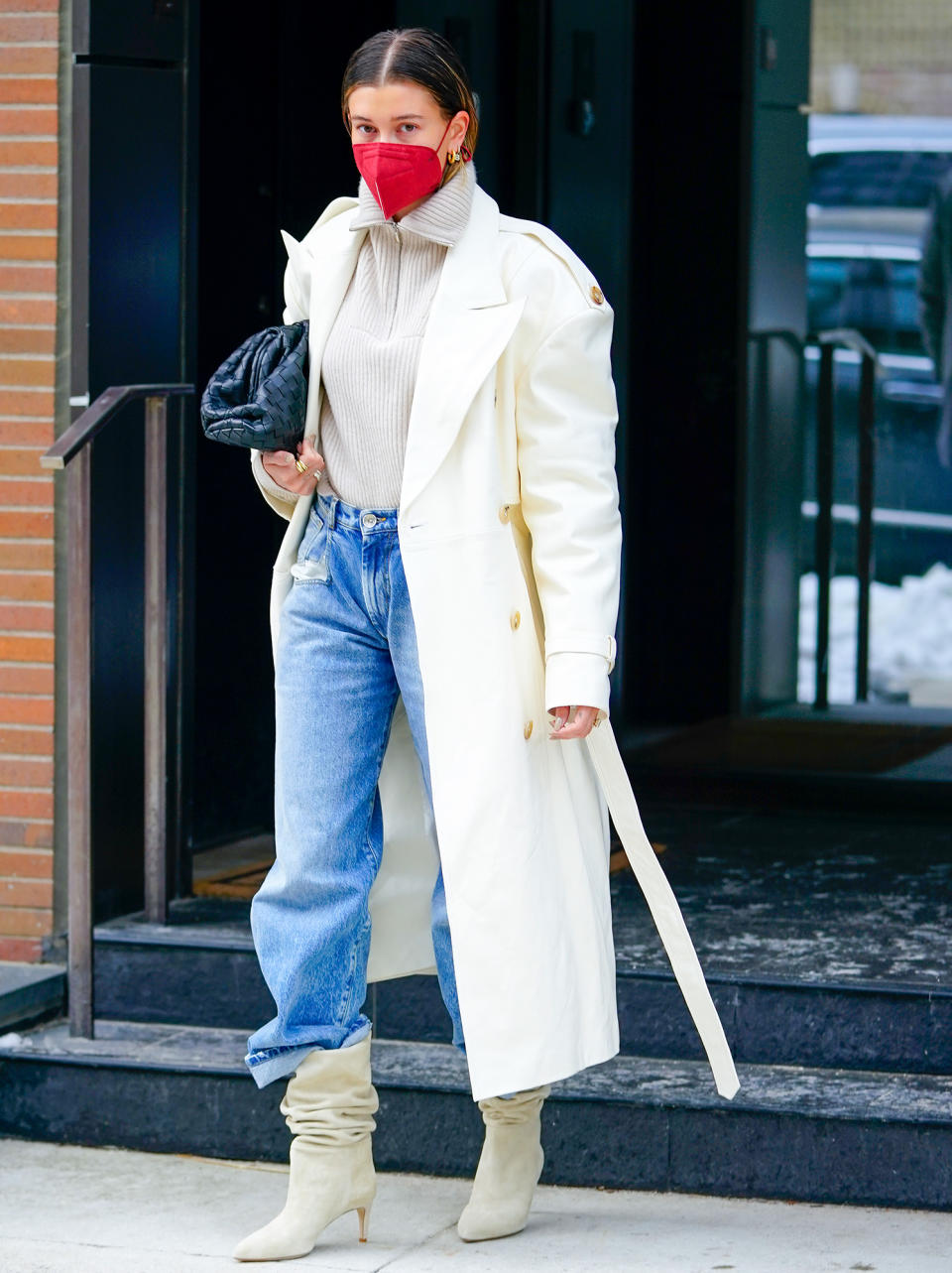 <p>Hailey Bieber looks incredibly chic in a long white coat, jeans and slouchy boots while headed to the studio in N.Y.C. on Monday.</p>