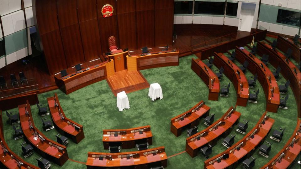 The Chinese national emblem is seen on the wall as it replaces the Hong Kong emblem at the Legislative chamber, before the Legislative Council election in Hong Kong, China, December 17, 2021. REUTERS/Tyrone Siu