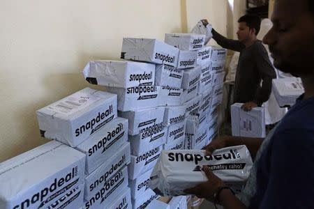 Employees of Snapdeal, an Indian online retailer, sort out delivery packages inside their company fulfilment centre in Mumbai October 22, 2014. REUTERS/Shailesh Andrade