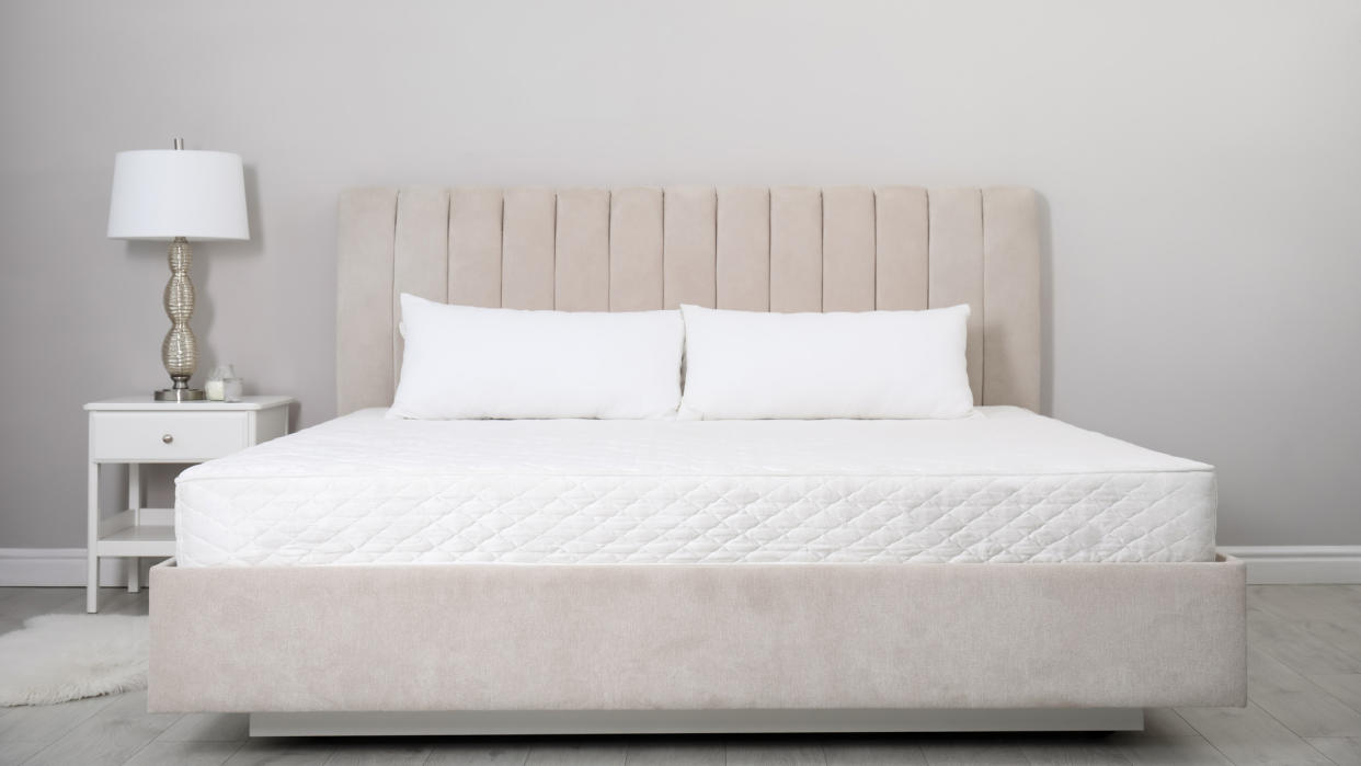  Image shows an Olympic queen mattress on a beige bedframe. 
