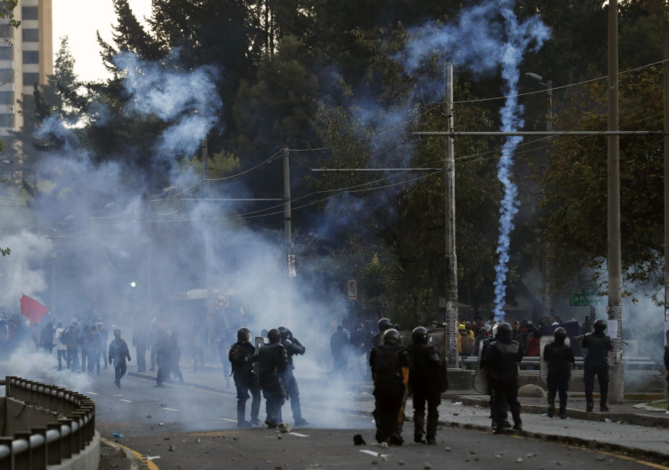 Police launch tear gas to disperse protesters in Quito, Ecuador, Friday, Oct. 4, 2019, during a nationwide transport strike that shut down taxi, bus and other services in response to a sudden rise in fuel prices. Ecuador's President Lenín Moreno, who earlier declared a state of emergency over the strike, vowed Friday that he wouldn't back down on the decision to end costly fuel subsidies, which doubled the price of diesel overnight and sharply raised gasoline prices. (AP Photo/Dolores Ochoa)