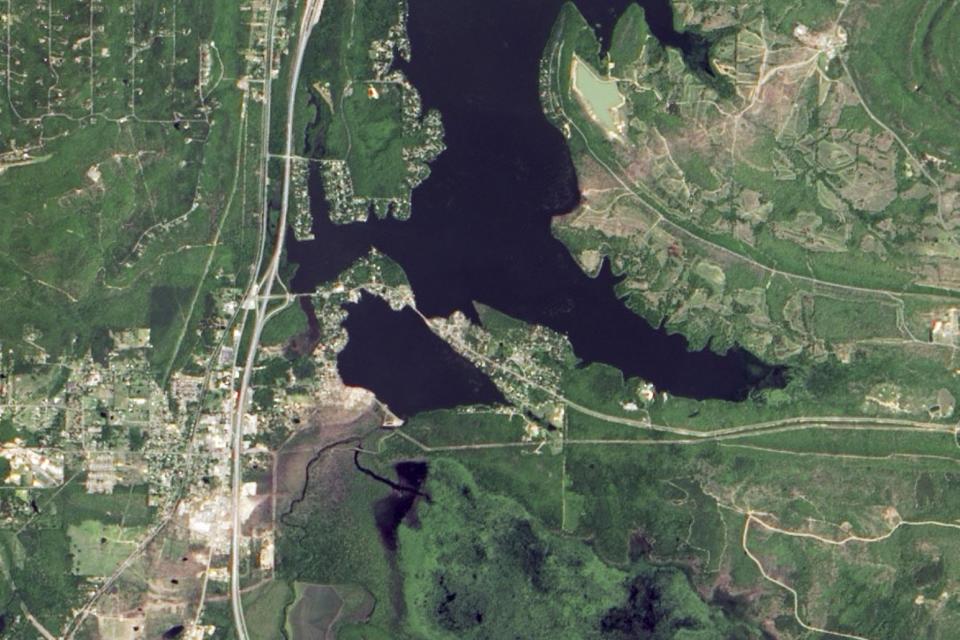 In this photo provided by NASA, taken from space by NASA's Earth Observatory May 2, 2014, the town of Mayflower, Ark., lower left, is shown six days after an EF4 tornado passed through the area. The storm's track can be seen trailing to the northeast, upper right, of the picture. (AP Photo/NASA Earth Observatory)