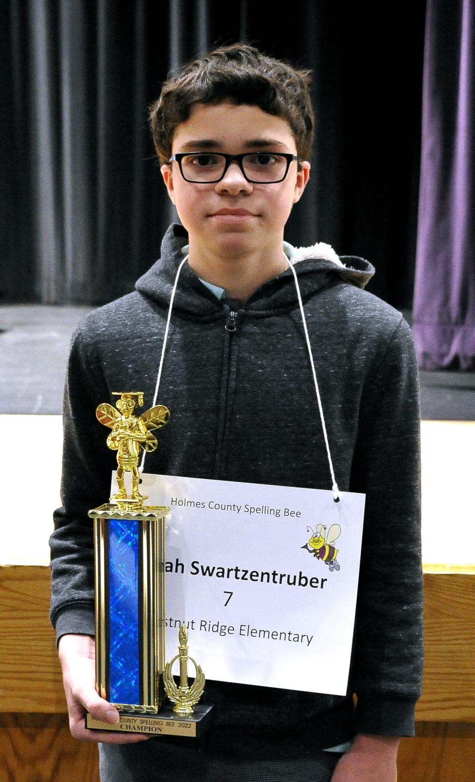 Isaiah Swartzentruber, a Chestnut Ridge seventh grader, correctly spells the word "repercussion" to win Thursday night's Holmes County Spelling Bee.