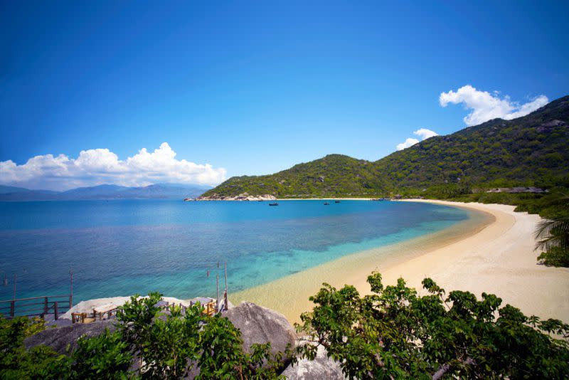 <p>Many words come to mind when describing the setting of the <a rel="nofollow noopener" href="http://www.sixsenses.com/SixSensesNinhVanBay" target="_blank" data-ylk="slk:Six Senses Ninh Van Bay;elm:context_link;itc:0;sec:content-canvas" class="link ">Six Senses Ninh Van Bay</a>, but the most accurate would be ‘surreal’. The setting is unparalleled and otherworldly–a painting come to life–in one of the more isolated and visually stunning settings in the world. </p><p>Incomparable and understated luxury typify this Six Senses haven, where you can enjoy sweeping views of the East Vietnam sea and it’s lush hillsides. Take them in by boat, bike or private sunken pool (in your villa). Prepare for a trip that's more seaworthy than airborne–you can only access this area by boat and you will immediately feel as though you're slipping into seclusion during the journey to this property. The best way to take in all that this area has to offer is by candlelight dinner as you watch the sunset across the horizon.</p>