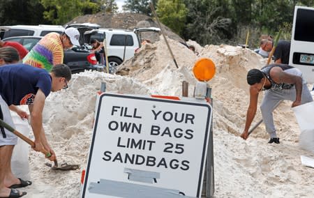 Local residents fill sandbags ahead of the arrival of Hurricane Dorian in Kissimmee