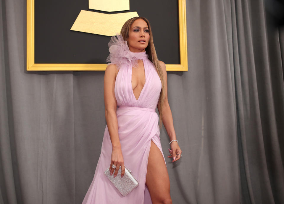 <p>Jennifer Lopez’s dress was quite a statement, so she accessorized her look with a simple white clutch. (Photo: Getty Images) </p>