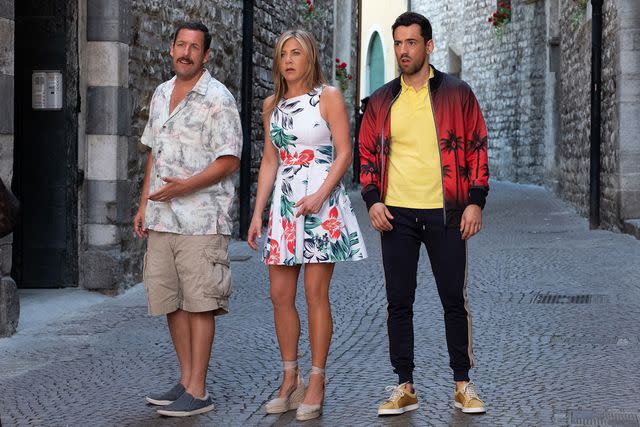 <p> Scott Yamano / Netflix</p> Adam Sandler, Jennifer Aniston, and Luis Gerardo Mendez in 'Murder Mystery'.