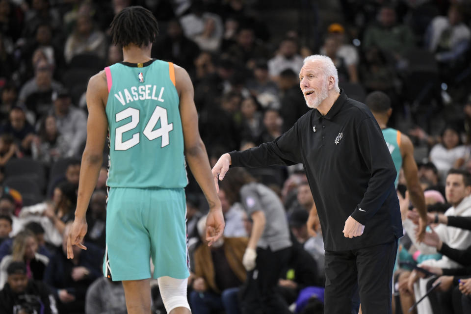 San Antonio Spurs head coach Gregg Popovich, right, talks to Spurs guard Devin Vassell during the second half of an NBA basketball game against the Milwaukee Bucks, Friday, Nov. 11, 2022, in San Antonio. San Antonio won 111-93. (AP Photo/Darren Abate)