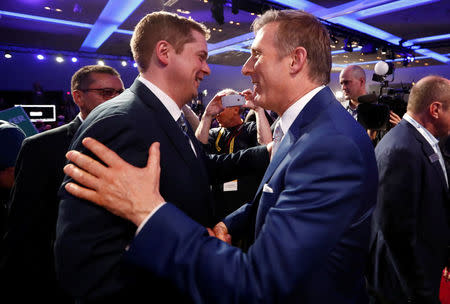 Andrew Scheer (L) is congratulated by runner up Maxime Bernier after Scheer won the leadership at the Conservative Party of Canada leadership convention in Toronto, Ontario, Canada, May 27, 2017. REUTERS/Mark Blinch