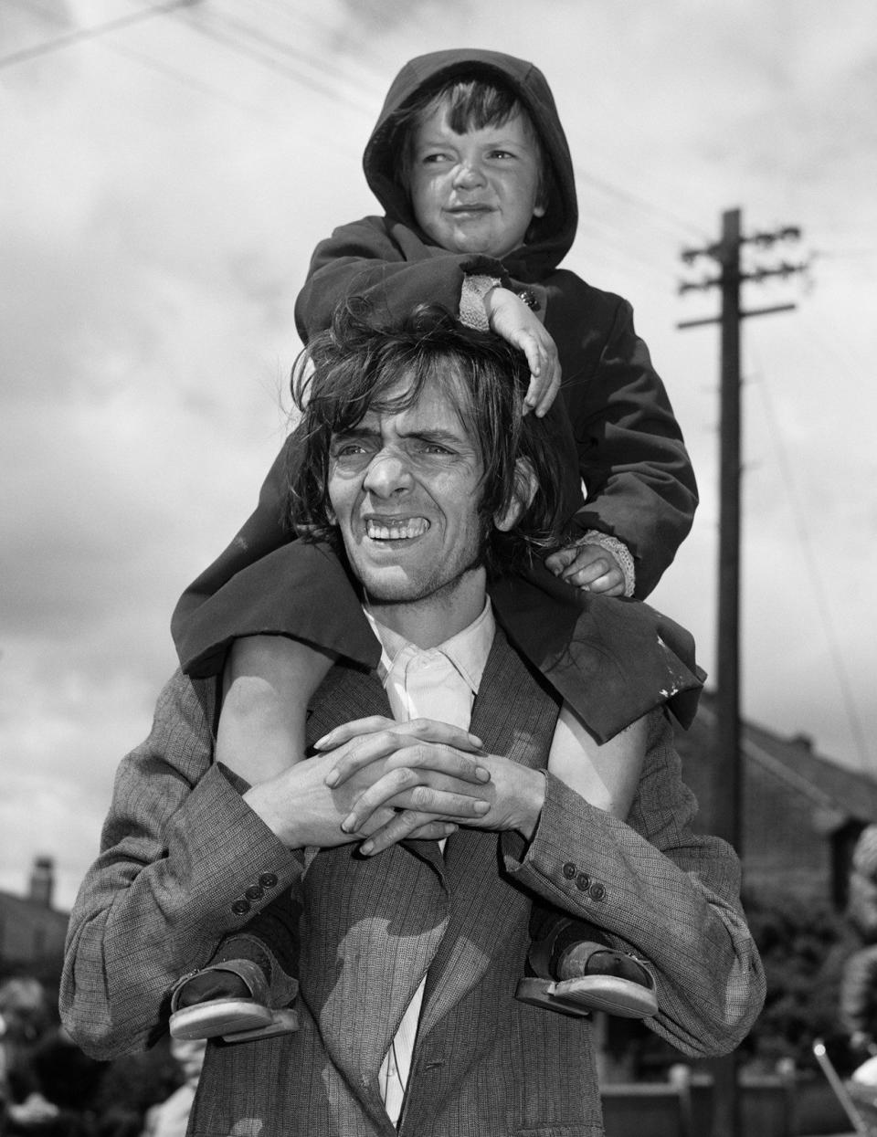 ‘He was on their side’: Father and son watching a parade, West End, Newcastle (1980) - Chris Killip