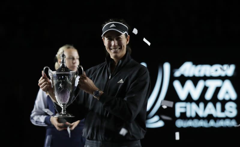 Garbiñe Muguruza celebra con el trofeo tras ganar el torneo WTA Finals