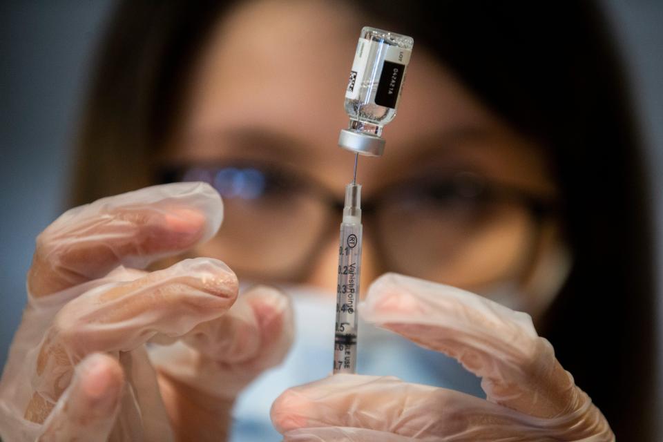 Pharmacist Anais Martinez prepares a COVID-19 vaccine to be administered April 9, 2021, at Holy Spirit Catholic Church in Horizon City, Texas.