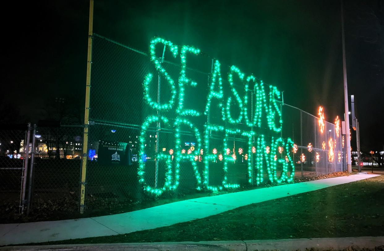 A large green lighting display wishes passersby "Seasons greetings" on Wednesday, Nov. 29, 2023, at Pine Grove Park in Port Huron.