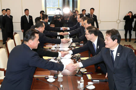 South and North Korean delegations attend their meeting at the truce village of Panmunjom in the demilitarised zone separating the two Koreas, South Korea, January 9, 2018. Yonhap via REUTERS