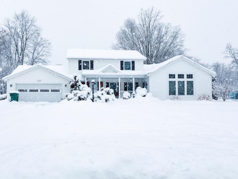 Stock photo of home covered in snow.
