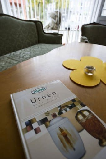 A catalogue for funeral urns lie on a table in burial firm Aarau. Some opt for a cut-price funeral because they are burying a distant relative; others because of geographical distance and the rest cite financial reasons