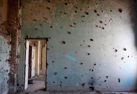 A wall damaged by bullets is seen at the Darul Aman palace in Kabul, Afghanistan, June 5, 2016. REUTERS/Omar Sobhani