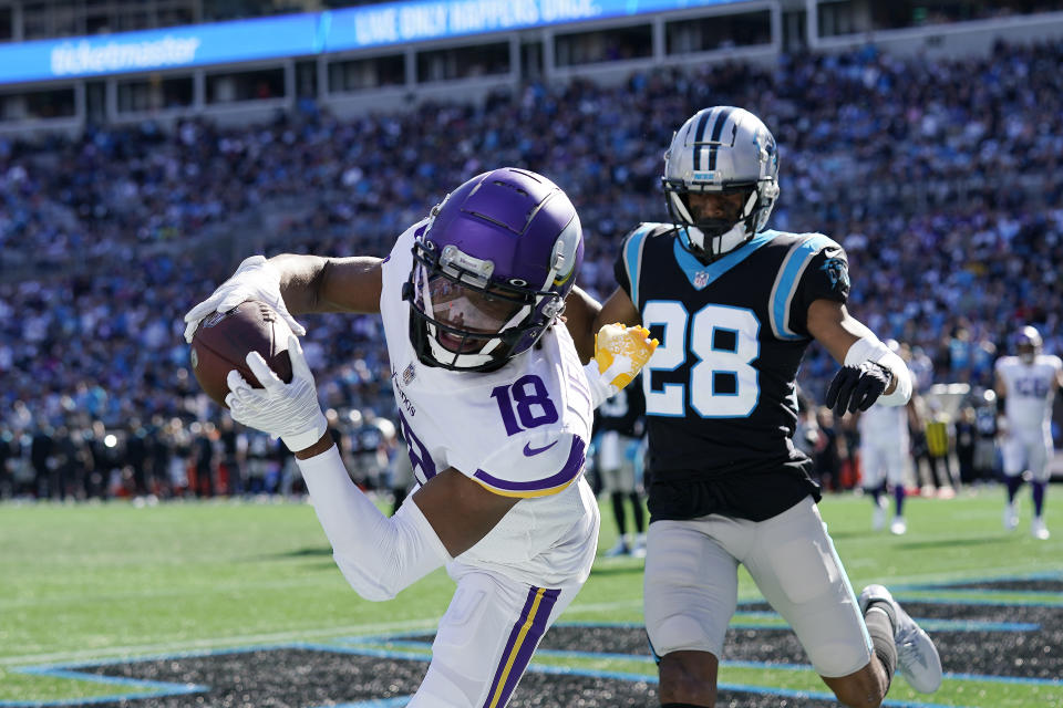 Minnesota Vikings wide receiver Justin Jefferson (18) makes the catch but out of bounds for a two-point conversion against Carolina Panthers cornerback Keith Taylor (28) during the second half of an NFL football game, Sunday, Oct. 17, 2021, in Charlotte, N.C. (AP Photo/Gerald Herbert)