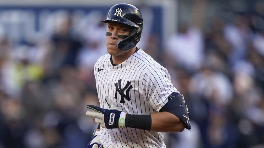 New York Yankees Aaron Judge rounds the bases after hitting a solo home run against the Cleveland Guardians.