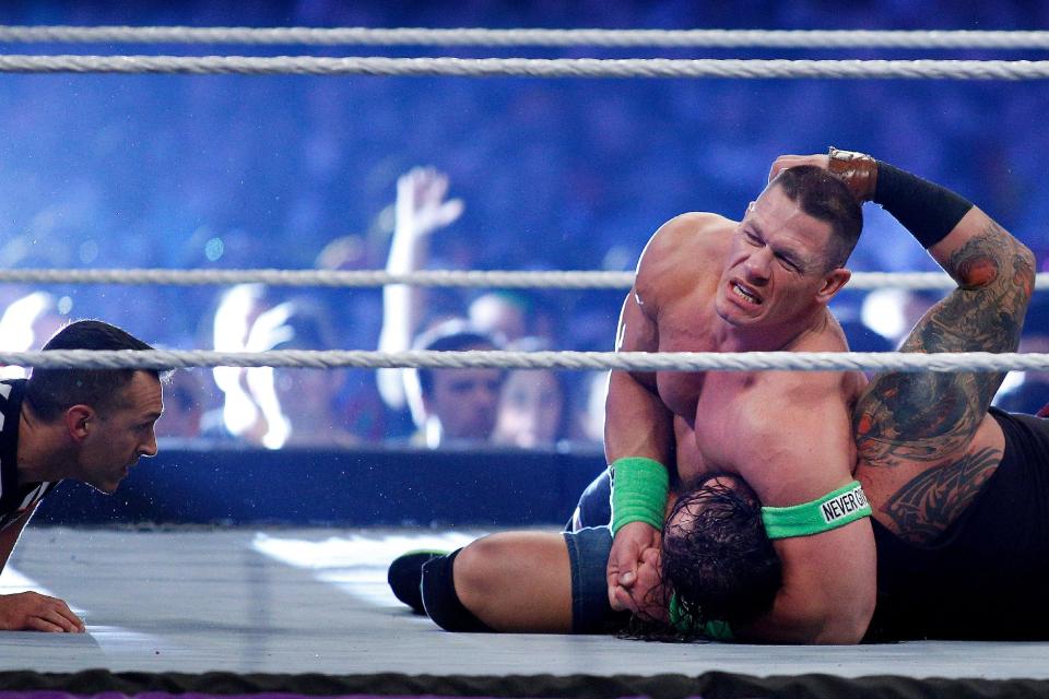 John Cena, top and Bray Wyatt, bottom compete during Wrestlemania XXX at the Mercedes-Benz Super Dome in New Orleans on Sunday, April 6, 2014. (Jonathan Bachman/AP Images for WWE)