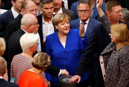 German Chancellor Angela Merkel gestures as members of the lower house of parliament Bundestag vote on legalising same-sex marriage, in Berlin, Germany June 30, 2017. REUTERS/Fabrizio Bensch