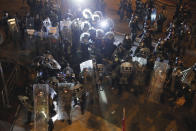 Riot police move into position in Wong Tai Sin district in Hong Kong on Saturday, Aug. 3, 2019. Protesters and authorities clashed in Hong Kong again on Saturday, as demonstrators removed a Chinese national flag from its pole and flung it into the city's iconic Victoria Harbour and police fired tear gas after some protesters vandalized a police station. (AP Photo/Kin Cheung)