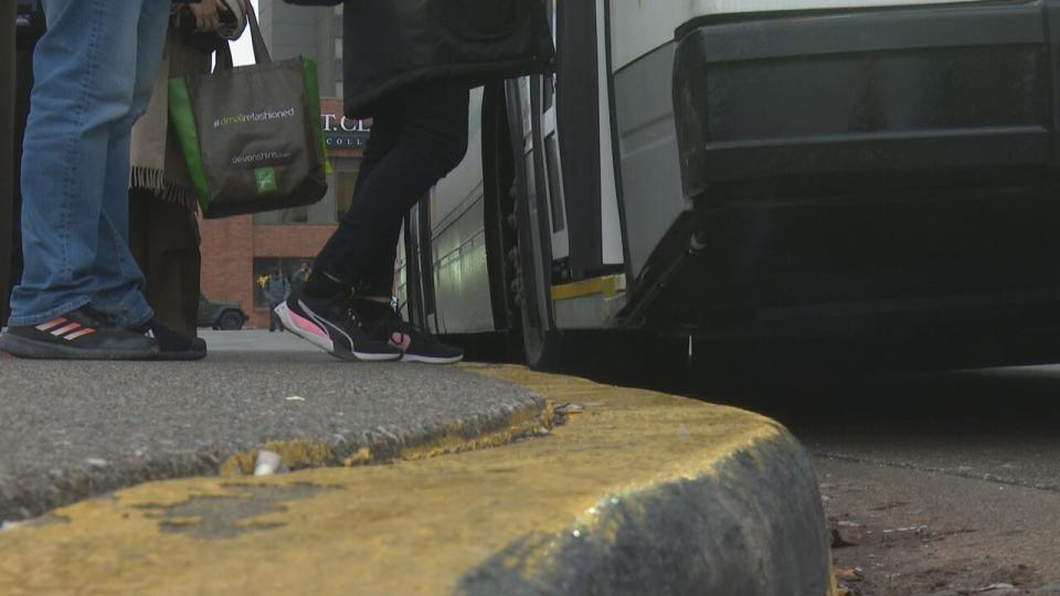 Riders line up for a Transit Windsor bus.