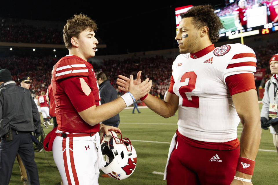 Nov 20, 2021; Madison, Wisconsin, USA; Wisconsin Badgers quarterback <a class="link " href="https://sports.yahoo.com/ncaaf/players/299744" data-i13n="sec:content-canvas;subsec:anchor_text;elm:context_link" data-ylk="slk:Graham Mertz;sec:content-canvas;subsec:anchor_text;elm:context_link;itc:0">Graham Mertz</a> (5) talks with <a class="link " href="https://sports.yahoo.com/ncaaf/teams/nebraska/" data-i13n="sec:content-canvas;subsec:anchor_text;elm:context_link" data-ylk="slk:Nebraska Cornhuskers;sec:content-canvas;subsec:anchor_text;elm:context_link;itc:0">Nebraska Cornhuskers</a> quarterback <a class="link " href="https://sports.yahoo.com/nfl/players/40299" data-i13n="sec:content-canvas;subsec:anchor_text;elm:context_link" data-ylk="slk:Adrian Martinez;sec:content-canvas;subsec:anchor_text;elm:context_link;itc:0">Adrian Martinez</a> (2) following the game at Camp Randall Stadium. Mandatory Credit: Jeff Hanisch-USA TODAY Sports