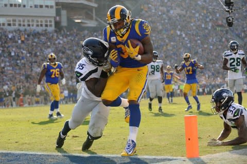 Los Angeles Rams running back Todd Gurley (30) runs in for a touchdown against Seattle Seahawks defensive end Dion Jordan (95) and free safety Tedric Thompson (33) during the first half at the Los Angeles Memorial Coliseum - Credit: Gary A. Vasquez/USA Today