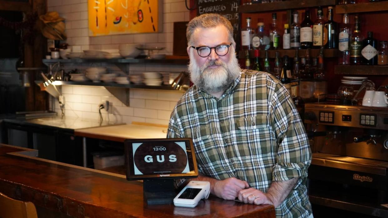 David Ferguson is the chef and owner of Gus, a restaurant in Montreal's Petite-Patrie neighbourhood. He is upset his point-of-sale supplier is trying to force him to use its payment system or be charged $200 a month.  (Dave St-Amant/CBC - image credit)