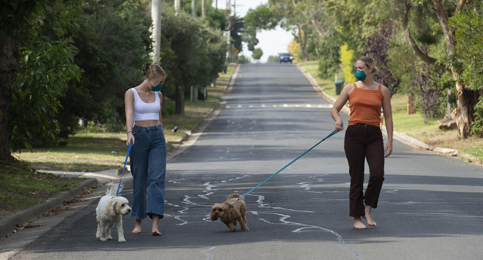 Two women using social distancing in the community.