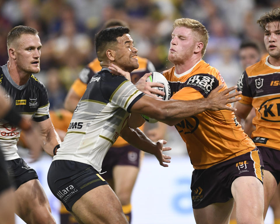 Thomas Flegler of the Broncos is tackled by Esan Marsters of the Cowboys during the round 1 NRL match between the North Queensland Cowboys and the Brisbane Broncos at  Queensland Country Bank  Stadium on March 13, 2020 in Townsville, Australia. (Photo by Ian Hitchcock/Getty Images)