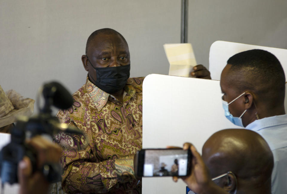 FILE - South African President and president of the African National Congress (ANC) Cyril Ramaphosa prepares to cast his vote in local elections in Soweto, South Africa, on Nov. 1, 2021. The ANC is to celebrate its 110th anniversary this weekend amid deep divisions, graft allegations and broad challenges that saw it perform dismally in local government elections last year. (AP Photo/Denis Farrell, File)