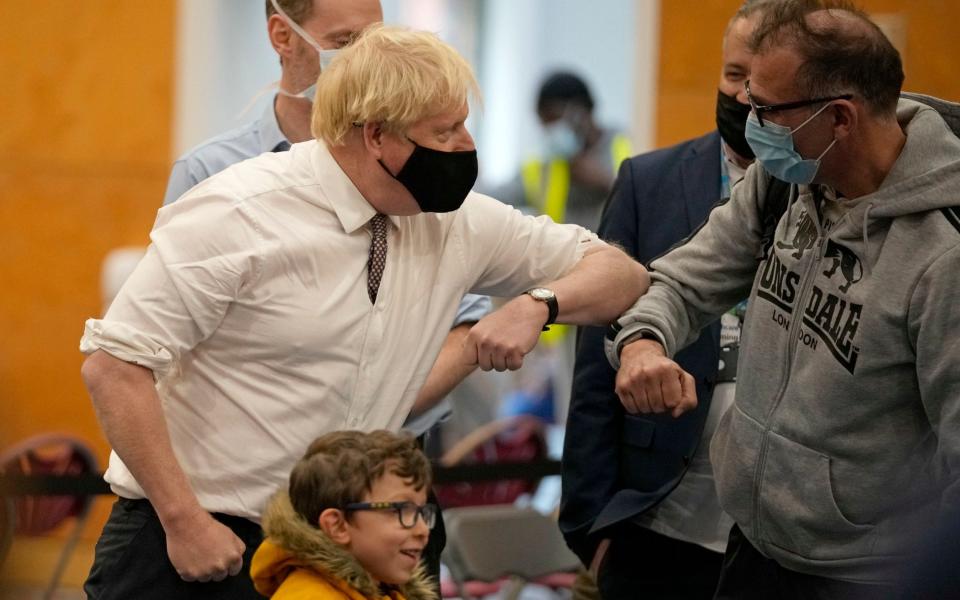 Johnson wore a mask as he met members of the public at a West London vaccine centre this afternoon - Matt Dunham/PA Wire