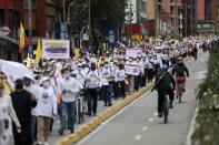 People march against road blockades in Bogota