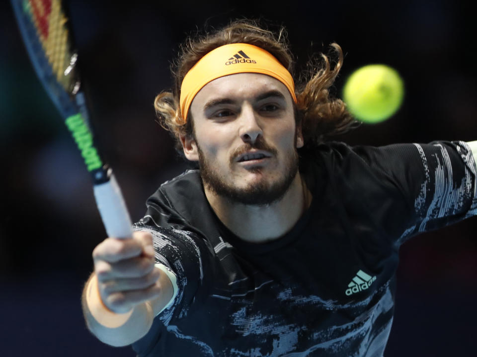 Stefanos Tsitsipas of Greece plays a return to Spain's Rafael Nadal during their ATP World Tours Finals singles tennis match at the O2 Arena in London, Friday, Nov. 15, 2019. (AP Photo/Alastair Grant)
